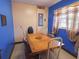 Cozy dining room with blue walls, a wooden table, and a window with curtains at 4902 Five Acre Rd, Plant City, FL 33565