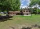 Charming two-story home with a well-manicured front lawn and mature trees at 4902 Five Acre Rd, Plant City, FL 33565