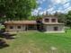 Attractive stucco home with a large front yard and mature trees creating a serene setting at 4902 Five Acre Rd, Plant City, FL 33565