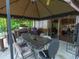 Covered gazebo with a table and chairs and a grill for outdoor dining at 4902 Five Acre Rd, Plant City, FL 33565