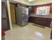Updated kitchen featuring stainless steel appliances, granite counters, and tiled flooring at 4902 Five Acre Rd, Plant City, FL 33565