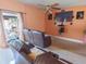 Open living room featuring tile flooring, a ceiling fan, and access to the lanai at 4902 Five Acre Rd, Plant City, FL 33565