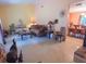 Open concept living room with tile floors, decorative furniture, and access to the dining area at 4902 Five Acre Rd, Plant City, FL 33565
