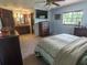 Spacious bedroom with TV, ceiling fan, and attached bathroom at 4902 Five Acre Rd, Plant City, FL 33565