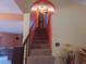 Carpeted staircase leading to the upper level with neutral wall and red archway at 4902 Five Acre Rd, Plant City, FL 33565