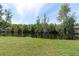 Scenic backyard view of a serene pond surrounded by lush greenery and trees at 4965 Anniston Cir, Tampa, FL 33647
