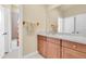 Well-lit bathroom with wooden vanity, large mirror, and a shower/bath combination, offering a clean and functional space at 4965 Anniston Cir, Tampa, FL 33647