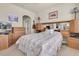 Bedroom featuring a bed with floral comforter, oak built ins, and an acoustic guitar at 4965 Anniston Cir, Tampa, FL 33647