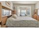 Bedroom featuring bay windows, exercise bike, wood built-ins, and floral bedspread at 4965 Anniston Cir, Tampa, FL 33647