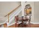 Charming dining area with a wooden table, staircase, and a view into the kitchen at 4965 Anniston Cir, Tampa, FL 33647