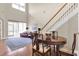 Dining room with hardwood floors, a staircase, and a view of the spacious living area at 4965 Anniston Cir, Tampa, FL 33647