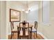 Cozy dining room with chandelier and natural light with warm wood table and chairs at 4965 Anniston Cir, Tampa, FL 33647