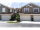 Charming townhome featuring a two-car garage, tidy landscaping, and a stucco exterior at 4965 Anniston Cir, Tampa, FL 33647