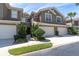 Well-maintained townhome exterior with a private entrance, two-car garage, and fresh landscaping at 4965 Anniston Cir, Tampa, FL 33647
