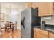 Functional kitchen with stainless steel appliances and wooden cabinets, located next to the dining area at 4965 Anniston Cir, Tampa, FL 33647