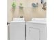 Laundry room with white washer and dryer plus shelving for laundry supplies at 4965 Anniston Cir, Tampa, FL 33647
