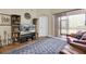 Cozy living area with a TV, sliding glass doors, and an area rug on top of hardwood floors at 4965 Anniston Cir, Tampa, FL 33647
