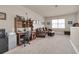 Spacious living room with a comfortable leather sectional, desk, and neutral carpet, creating a cozy and functional space at 4965 Anniston Cir, Tampa, FL 33647
