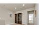 Loft with two bookshelves, neutral paint and carpet plus hallway to other rooms at 4965 Anniston Cir, Tampa, FL 33647