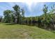Peaceful waterfront with a grassy bank leading to a tranquil lake, perfect for relaxation at 4965 Anniston Cir, Tampa, FL 33647