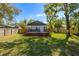 Charming home with a wooden deck, complemented by a fenced backyard and lush landscaping at 5108 N Suwanee Ave, Tampa, FL 33603