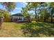 Charming home featuring a spacious backyard and a wooden deck, perfect for outdoor entertaining at 5108 N Suwanee Ave, Tampa, FL 33603