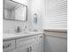 Bright bathroom featuring a vanity with a marble countertop, a mirror, and natural light at 5108 N Suwanee Ave, Tampa, FL 33603