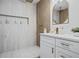 Luxurious bathroom featuring double shower heads, built-in shelves, and sleek modern vanity at 5108 N Suwanee Ave, Tampa, FL 33603