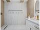 Modern bathroom with a walk-in shower, dual shower heads, a built-in shelf and a double sink vanity at 5108 N Suwanee Ave, Tampa, FL 33603