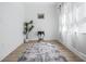 Bedroom showcasing a decorative rug, plant, and small table near a window with light-filtering curtains at 5108 N Suwanee Ave, Tampa, FL 33603