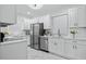 Beautiful kitchen with stainless steel appliances, white cabinets, and marble countertops at 5108 N Suwanee Ave, Tampa, FL 33603