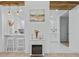 Open living area with electric fireplace, bar seating, and view to the kitchen at 5108 N Suwanee Ave, Tampa, FL 33603