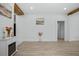 Open living space with wood beam accents, light wood floors, and neutral color palette at 5108 N Suwanee Ave, Tampa, FL 33603