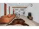 Open-concept living room with light wood floors, neutral decor, and a view into the kitchen at 5108 N Suwanee Ave, Tampa, FL 33603