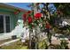 Front yard trellis with climbing red roses, enhancing the curb appeal of this charming home at 5184 61St N Ln, Kenneth City, FL 33709