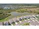 Scenic aerial view of homes bordering a serene lake in a residential community at 5411 Thistle Field Ct, Wesley Chapel, FL 33545