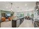 View of the kitchen island, dining room, and living room in an open floor plan at 5411 Thistle Field Ct, Wesley Chapel, FL 33545