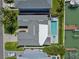 Aerial view of a house featuring a pool, spa and manicured backyard at 556 Johns Pass Ave, Madeira Beach, FL 33708