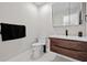 Modern bathroom with a floating wood vanity, white countertop, and black faucet at 556 Johns Pass Ave, Madeira Beach, FL 33708
