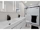 Bathroom featuring double sinks, black fixtures, modern shower and black and white tiles at 556 Johns Pass Ave, Madeira Beach, FL 33708