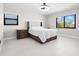 Bright bedroom featuring two windows, bedside tables and a ceiling fan at 556 Johns Pass Ave, Madeira Beach, FL 33708