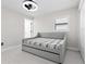 Bright bedroom features a bed with plaid cover, overhead fan, and closet storage at 556 Johns Pass Ave, Madeira Beach, FL 33708