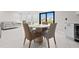 Cozy dining area next to the open kitchen with modern furniture and bright lighting at 556 Johns Pass Ave, Madeira Beach, FL 33708