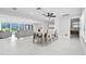Open-concept dining room with views to the pool and an modern ceiling fan at 556 Johns Pass Ave, Madeira Beach, FL 33708