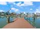 Waterfront property with a private dock, boat lift and serene canal views on a sunny day at 556 Johns Pass Ave, Madeira Beach, FL 33708