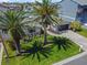 Beautiful aerial view of a single-story home with palm trees and manicured lawn at 556 Johns Pass Ave, Madeira Beach, FL 33708