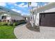Beautiful home exterior with landscaped walkway, brick driveway, and well-maintained lawn at 556 Johns Pass Ave, Madeira Beach, FL 33708