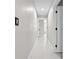 Bright hallway with neutral paint and tile flooring leads to various rooms within the home at 556 Johns Pass Ave, Madeira Beach, FL 33708
