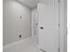 Hallway featuring white doors and white tile floors at 556 Johns Pass Ave, Madeira Beach, FL 33708