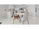 Bright kitchen and dining area featuring white cabinetry and modern appliances at 556 Johns Pass Ave, Madeira Beach, FL 33708